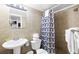 The bathroom features a toilet, sink, and walk-in shower with tan tiles at 2600 S Ocean Blvd. # 215, Myrtle Beach, SC 29577