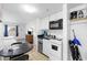 This kitchenette features white cabinets and appliances, as well as a black table with chairs at 2600 S Ocean Blvd. # 215, Myrtle Beach, SC 29577