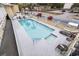 A refreshing, rectangular in-ground pool with poolside seating is surrounded by white fencing and lush green palm trees at 2600 S Ocean Blvd. # 215, Myrtle Beach, SC 29577