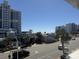 Street view featuring a mix of buildings, palm trees, and a glimpse of the ocean at 2708 S Ocean Blvd. S # 302, Myrtle Beach, SC 29577