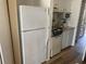 Efficient kitchen with full sized refrigerator, stove, microwave, and neutral countertops at 2708 S South Ocean Blvd. # 102, Myrtle Beach, SC 29577