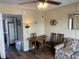 Cozy living and dining area with hardwood-style floors and a comfortable sofa at 2708 S South Ocean Blvd. # 102, Myrtle Beach, SC 29577