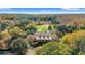 Aerial shot of beautiful estate with a golf course in the background surrounded by trees at 30 Baldwin Loop, Pawleys Island, SC 29585