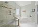 Modern bathroom with a glass-enclosed shower, soaking tub, and stylish tile work at 30 Baldwin Loop, Pawleys Island, SC 29585