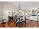 Cozy dining area with hardwood floors, a stylish chandelier, and direct access to the living room at 30 Baldwin Loop, Pawleys Island, SC 29585