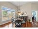 Cozy dining area featuring hardwood floors, stylish lighting and round table near natural light from large window at 30 Baldwin Loop, Pawleys Island, SC 29585