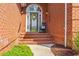A beautiful brick front porch with a lovely wreath and black rocking chair welcomes you at 30 Baldwin Loop, Pawleys Island, SC 29585