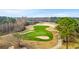 Scenic aerial view of golf course with beautiful green, sand traps, and mature trees at 30 Baldwin Loop, Pawleys Island, SC 29585