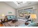 Bright living room with a ceiling fan, skylights, and access to the screened-in porch at 30 Baldwin Loop, Pawleys Island, SC 29585