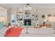 Bright living room featuring a fireplace, built-in shelving, and views into other living spaces at 30 Baldwin Loop, Pawleys Island, SC 29585