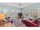 Comfortable living room with hardwood floors, ample natural light, and a classic ceiling fan at 30 Baldwin Loop, Pawleys Island, SC 29585
