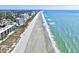 Stunning aerial view showcasing the coastline with sandy beaches, ocean, and nearby buildings at 300 Lorenzo Dr., North Myrtle Beach, SC 29582