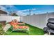 Cozy backyard with artificial turf, lounge chairs, and a well-maintained privacy fence at 300 Lorenzo Dr., North Myrtle Beach, SC 29582