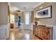 Welcoming foyer with hardwood floors, decorative console table, and elegant front door with glass panels at 300 Lorenzo Dr., North Myrtle Beach, SC 29582