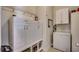 Well-organized laundry room with white cabinets, open storage, and a deep freezer at 300 Lorenzo Dr., North Myrtle Beach, SC 29582
