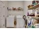 Functional laundry area with a washer, dryer, shelving, and ample storage space at 300 Lorenzo Dr., North Myrtle Beach, SC 29582