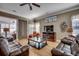 Comfortable living room featuring hardwood floors, leather sofas, a ceiling fan, and sliding door to a patio at 300 Lorenzo Dr., North Myrtle Beach, SC 29582