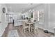 Bright dining area with a table set for four, modern lighting, and a view into the kitchen at 3534 Pampas Dr. # 505, Myrtle Beach, SC 29577