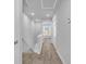 Hallway with carpet and white walls leading to a room with natural light at 3534 Pampas Dr. # 505, Myrtle Beach, SC 29577