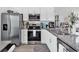 Modern kitchen with stainless steel appliances, granite countertops, and white cabinetry at 3534 Pampas Dr. # 505, Myrtle Beach, SC 29577