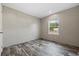 This bedroom features stylish wood-look flooring and a window letting in natural light at 3685 Nichols Hwy., Aynor, SC 29511