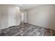 This bedroom features a neutral color palette and wood-look flooring and two doors at 3685 Nichols Hwy., Aynor, SC 29511