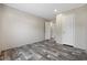 This bedroom features a neutral color palette and wood-look flooring and two doors at 3685 Nichols Hwy., Aynor, SC 29511