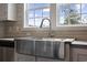 A large stainless steel farmhouse sink with modern faucet is the highlight in this bright kitchen at 3685 Nichols Hwy., Aynor, SC 29511