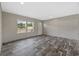 Bright and airy living room featuring wood-look flooring, a large window, and neutral walls at 3685 Nichols Hwy., Aynor, SC 29511