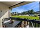 Relaxing balcony featuring seating for two and an outdoor view of the grounds and parking area at 405 21St Ave. S # 1-O, North Myrtle Beach, SC 29582