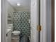 Bathroom featuring a shower/tub combo with green patterned shower curtain and tile flooring at 405 21St Ave. S # 1-O, North Myrtle Beach, SC 29582