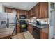 Efficient kitchen with stainless steel refrigerator, black appliances, and wood cabinets at 405 21St Ave. S # 1-O, North Myrtle Beach, SC 29582