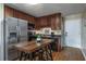Efficient kitchen featuring stainless steel refrigerator, black appliances, and wood cabinets at 405 21St Ave. S # 1-O, North Myrtle Beach, SC 29582