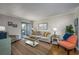 Inviting living room featuring cozy furnishings, wood floors, and sliding glass door to a covered balcony at 405 21St Ave. S # 1-O, North Myrtle Beach, SC 29582