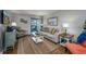 Bright living room with comfortable seating, wood floors, and sliding glass door to a covered balcony at 405 21St Ave. S # 1-O, North Myrtle Beach, SC 29582