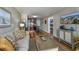 Well-lit living room showcases comfortable seating, wood floors, and a view into the kitchen and bunk room at 405 21St Ave. S # 1-O, North Myrtle Beach, SC 29582