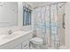 Bright bathroom featuring a shower and bathtub combo with a shower curtain and a window with a curtain at 413 30Th Ave. N, Myrtle Beach, SC 29577