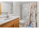 Bathroom featuring a shower and bathtub combo with a shower curtain and a vanity at 413 30Th Ave. N, Myrtle Beach, SC 29577
