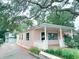 Inviting exterior showcases a well-maintained home with a cozy front porch and vibrant floral landscaping at 413 30Th Ave. N, Myrtle Beach, SC 29577