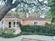 Charming exterior with lush greenery, mature trees, and a cozy porch creates a private outdoor space at 413 30Th Ave. N, Myrtle Beach, SC 29577