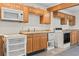 Functional kitchen featuring wood cabinetry, essential appliances, and ample counter space at 413 30Th Ave. N, Myrtle Beach, SC 29577