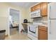 Cozy kitchen adjacent to bedroom featuring essential appliances and space-saving design at 413 30Th Ave. N, Myrtle Beach, SC 29577