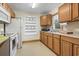 Functional kitchen with wood cabinets, white appliances, and open shelving for storage and display at 413 30Th Ave. N, Myrtle Beach, SC 29577