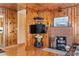Cozy living room with wood paneling, hardwood floors, fireplace, and TV at 413 30Th Ave. N, Myrtle Beach, SC 29577
