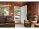 Comfortable living room featuring wood paneled walls and two leather couches at 413 30Th Ave. N, Myrtle Beach, SC 29577