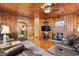 Living room featuring wood paneling, hardwood floors, and a brick fireplace at 413 30Th Ave. N, Myrtle Beach, SC 29577