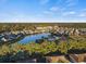 A serene aerial view of the lakefront community with lush landscaping and a swimming pool at 4222 Pinehurst Dr. # I-9, Little River, SC 29566