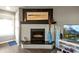 Elegant fireplace with mantel, a TV, decor, and a bright window, creating a focal point for comfort and style at 4222 Pinehurst Dr. # I-9, Little River, SC 29566