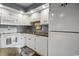Efficient kitchen space with white cabinets and appliances, ready for home-cooked meals at 4222 Pinehurst Dr. # I-9, Little River, SC 29566
