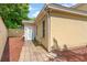 Side backyard with neutral stucco wall and brick paver walk way at 4306 Windy Heights Dr., North Myrtle Beach, SC 29582